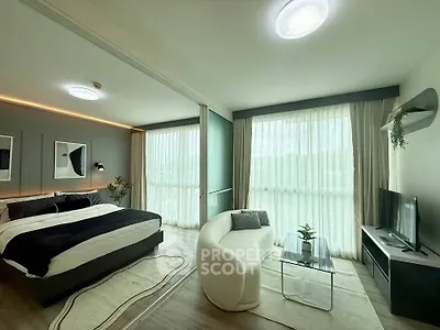 Modern bedroom with stylish decor and large windows for natural light.
