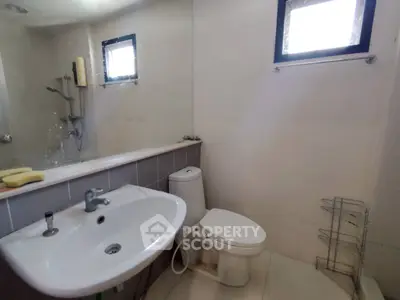 Modern bathroom with sleek fixtures and natural light, perfect for a contemporary home.