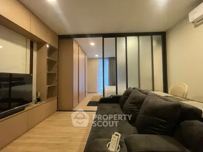 Modern living room with sleek design and cozy atmosphere, featuring a plush sofa and stylish sliding doors.