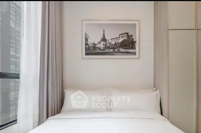 Cozy bedroom with elegant decor and large window in modern apartment.