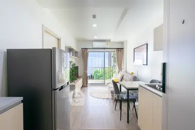 Modern open-layout living room with balcony and sleek kitchen appliances