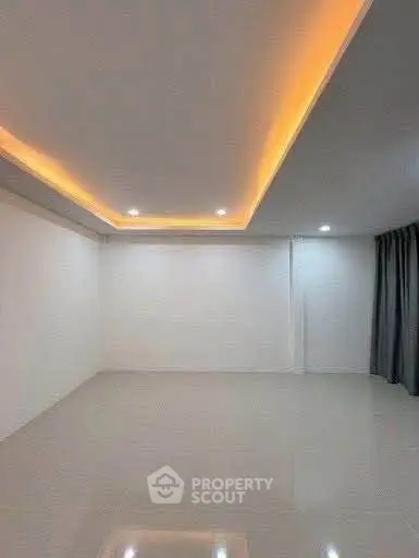 Spacious modern room with sleek lighting and glossy flooring, perfect for versatile interior design.