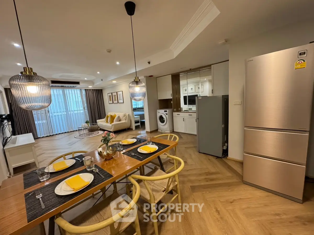 Spacious open-plan living and dining area with modern kitchen appliances and elegant decor.