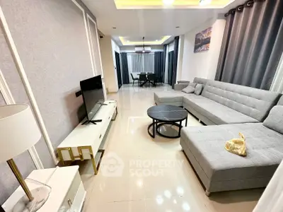 Modern living room with sleek gray sofa and stylish decor in a contemporary apartment.
