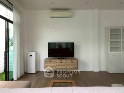 Modern living room with sleek TV setup and stylish wooden furniture