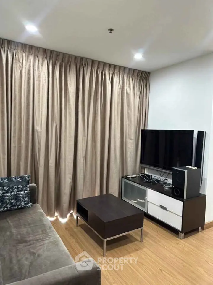 Cozy living room with modern furniture and entertainment setup, perfect for relaxation.