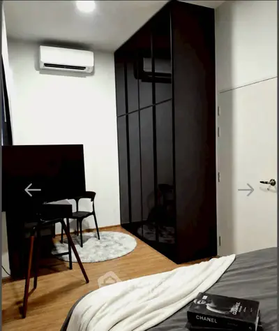 Modern bedroom with sleek black wardrobe and cozy decor