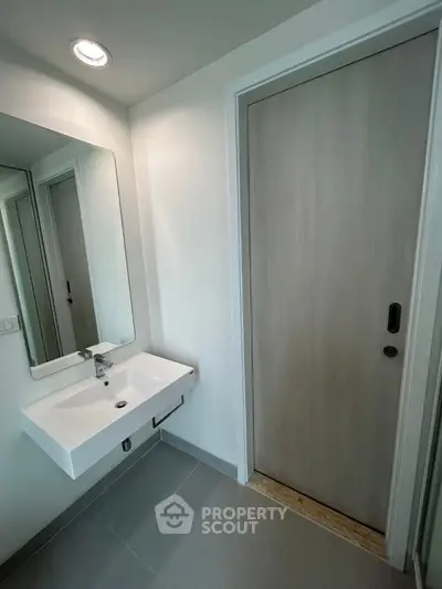 Modern bathroom with sleek sink and large mirror