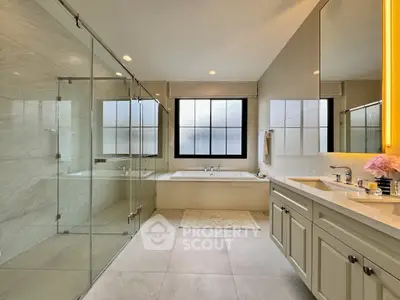 Luxurious bathroom with glass shower and elegant bathtub