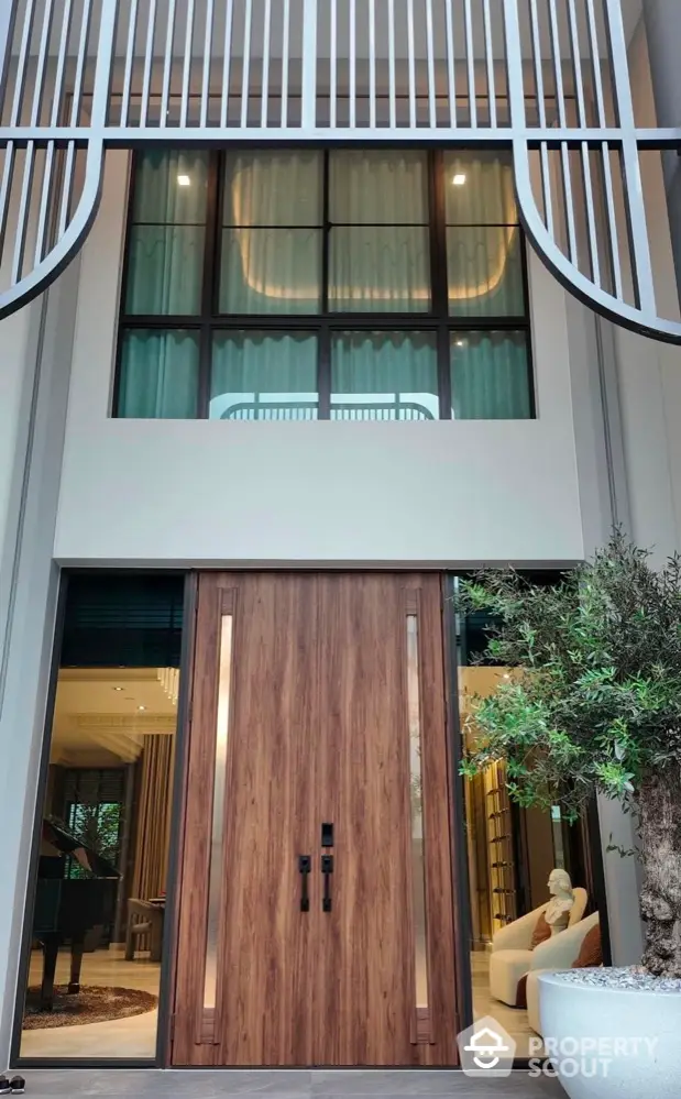 Luxurious modern entrance with grand wooden door and stylish architecture