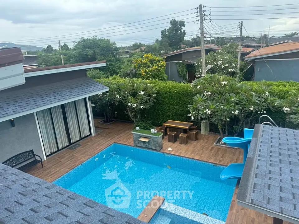 Luxurious backyard with sparkling pool and lush greenery, perfect for relaxation and entertainment.
