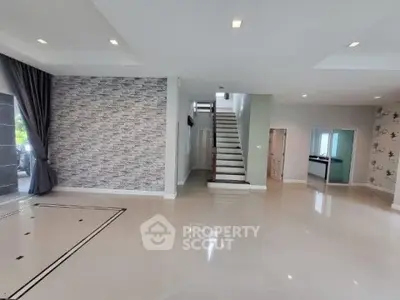 Spacious modern living room with elegant staircase and stylish decor