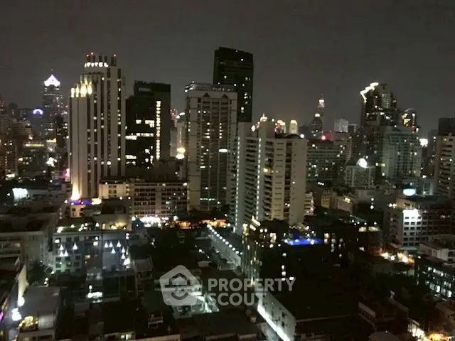 Stunning nighttime cityscape view showcasing illuminated skyscrapers and vibrant urban life.