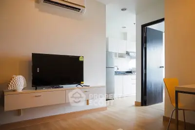 Modern apartment interior with sleek kitchen and cozy living area, perfect for urban living.