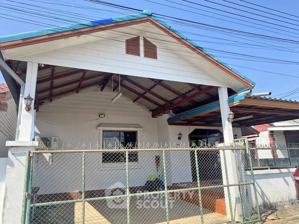 Charming single-story house with a fenced yard and covered porch, perfect for cozy living.