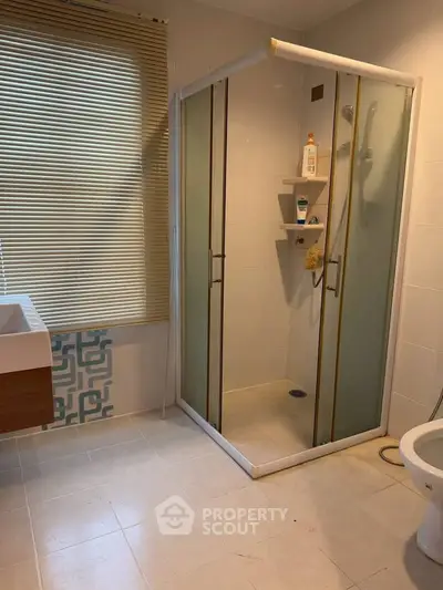 Modern bathroom with glass shower enclosure and stylish sink