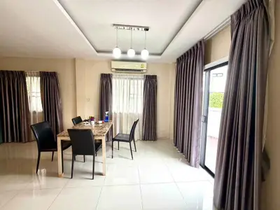 Spacious dining area with modern decor and large windows for natural light.