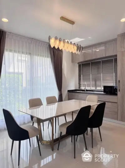 Elegant dining area with modern chandelier and sleek furniture