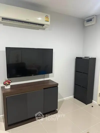 Modern living room with sleek TV stand and air conditioning unit, perfect for cozy entertainment.