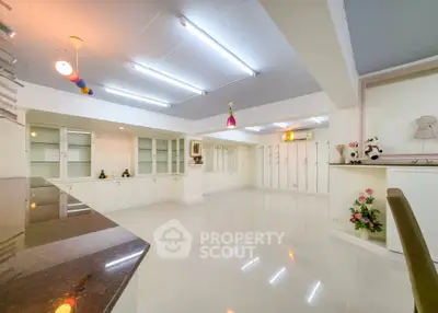 Spacious modern living room with sleek white cabinetry and polished floors