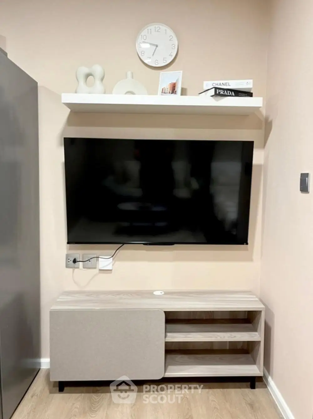 Modern living room with wall-mounted TV and stylish shelving