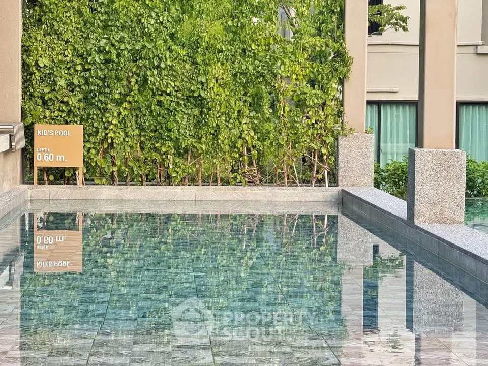 Luxurious kid's pool with lush greenery and modern design, perfect for family relaxation.