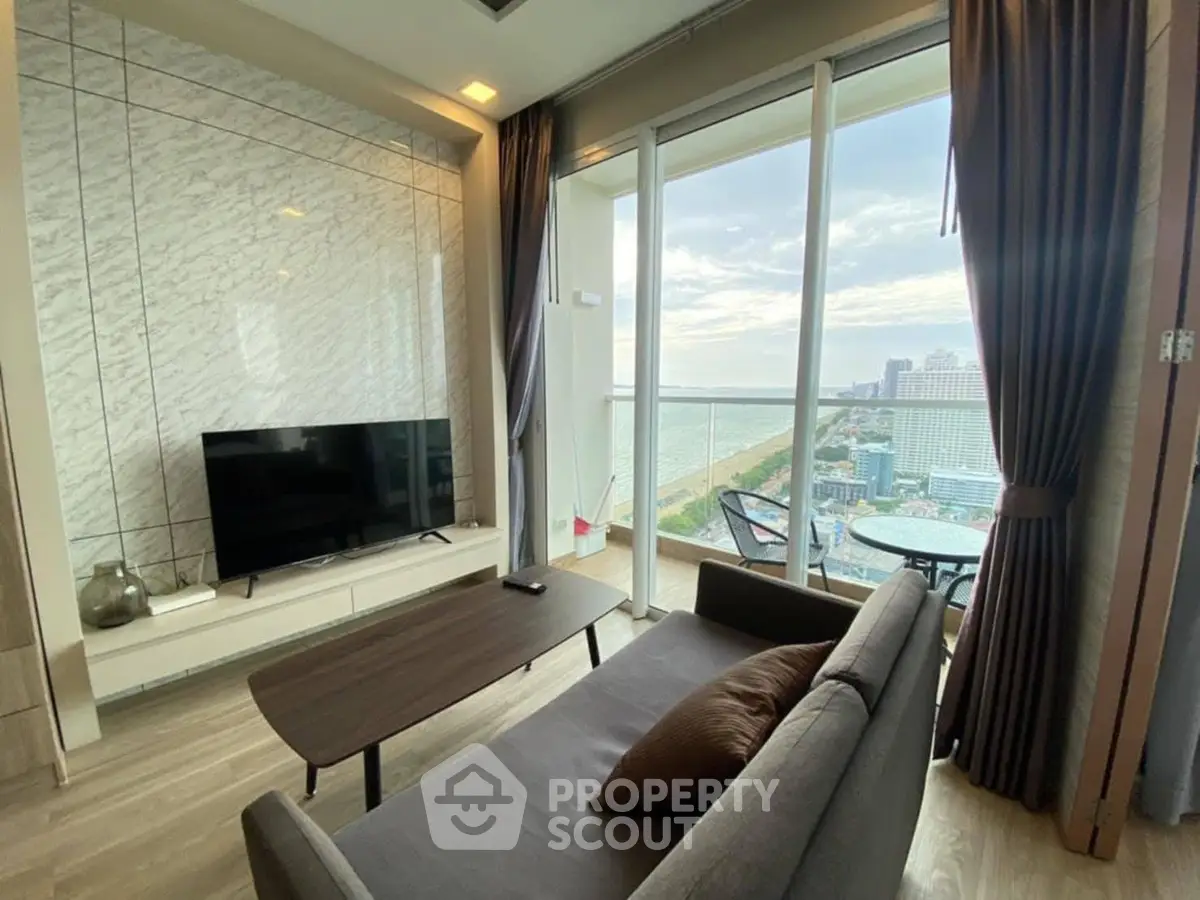 Modern living room with stunning ocean view and floor-to-ceiling windows.