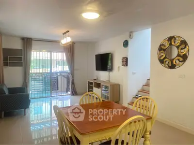 Spacious living room with modern decor and natural light, perfect for family gatherings.