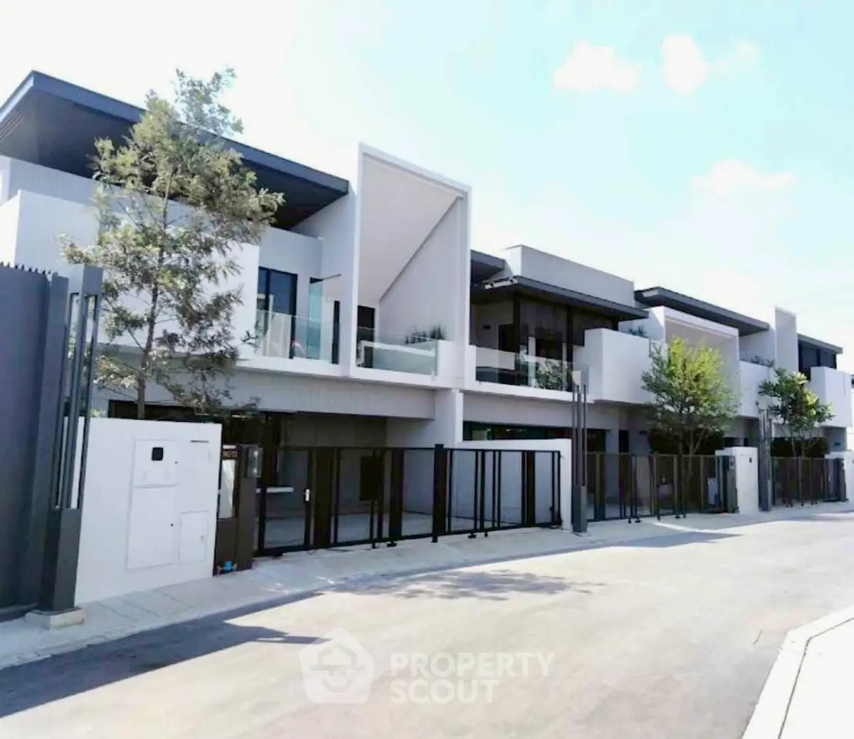 Modern luxury townhouse with sleek design and spacious balconies in a serene neighborhood.
