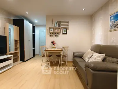 Cozy living room with modern decor, featuring a comfortable sofa, dining table, and stylish shelving.