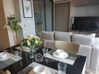Modern living room with elegant dining setup and cozy sofa in stylish apartment.
