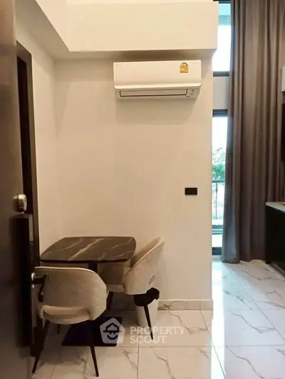 Modern dining nook with marble table and air conditioning in a stylish apartment.