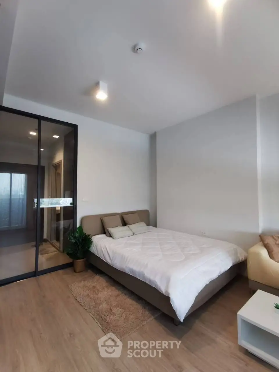 Modern bedroom with cozy bed and stylish decor in a contemporary apartment.