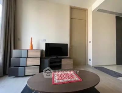Modern living room with stylish furniture and TV setup, perfect for relaxation.