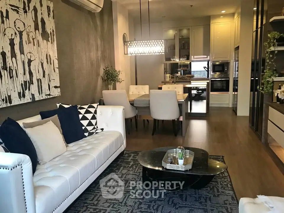 Luxurious modern living room with elegant decor and open kitchen layout, perfect for stylish urban living.