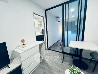 Modern apartment interior with sleek design and open layout, featuring a stylish dining area and cozy living space.