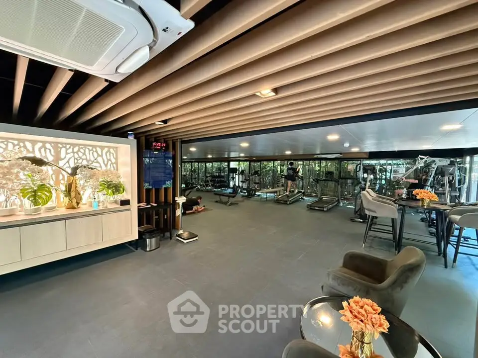 Luxurious gym with modern equipment and stylish decor in a high-end residential building.