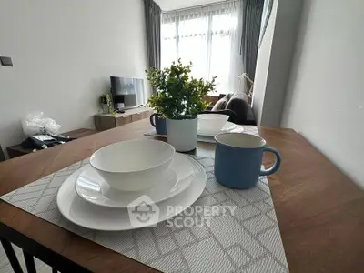 Modern living room with dining table setup and natural light