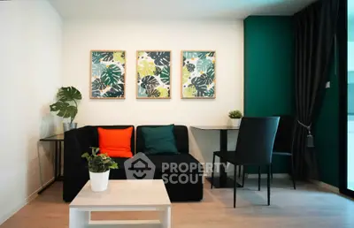 Modern living room with stylish decor and vibrant artwork, featuring a cozy seating area and elegant furnishings.