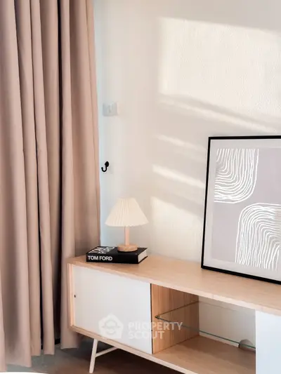 Stylish modern living room corner with elegant decor and soft lighting.