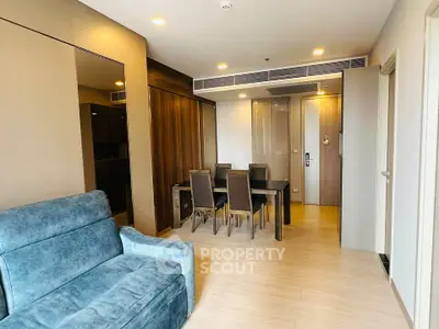 Modern living room with dining area and stylish furniture in a cozy apartment.