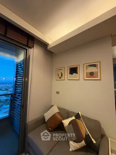 Cozy living room with modern decor and city view from balcony.