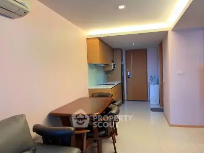 Modern apartment interior with cozy dining area and compact kitchen layout.