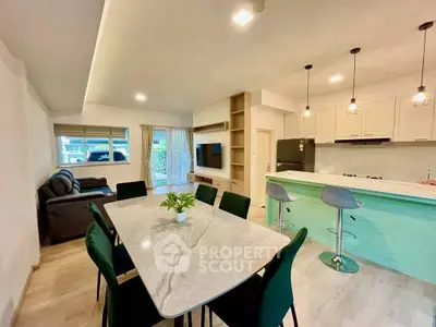 Spacious open-plan living and dining area with modern kitchen and stylish decor.