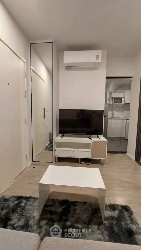 Modern living room with sleek furniture and air conditioning in a stylish apartment.