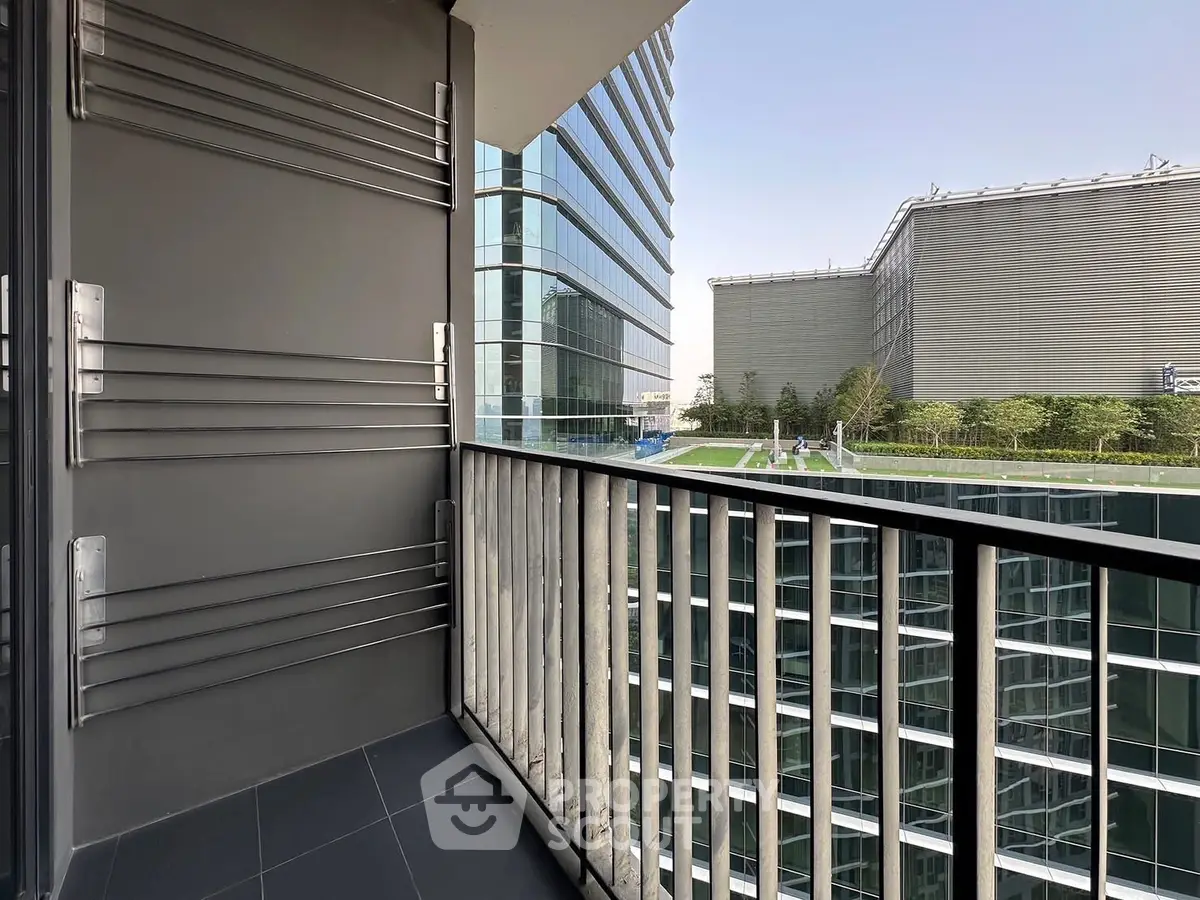 Modern balcony with sleek railing and cityscape view, perfect for urban living.