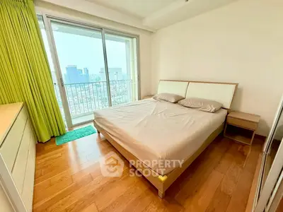 Bright bedroom with city view and wooden flooring in modern apartment