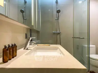 Modern bathroom with sleek fixtures and glass shower enclosure