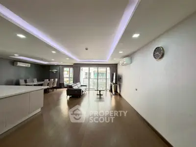 Spacious modern living room with open layout and elegant lighting