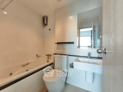 Modern bathroom with bathtub and sleek fixtures in a contemporary apartment.